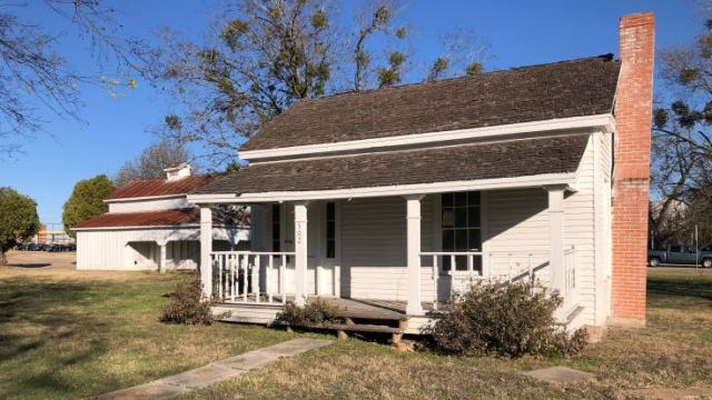 CoulterSquare122420bldgs_feat In the foreground, the city of Bryan's Coulter Square home built in 1867 on December 24, 2020.