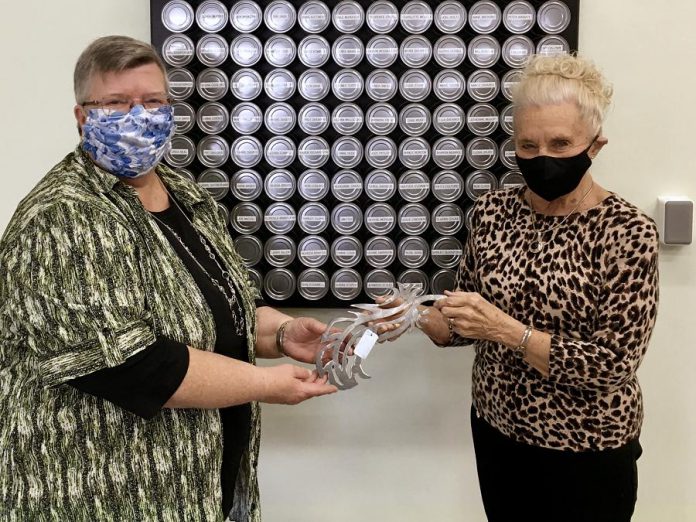 Kawartha Lakes Food Source volunteer Donna McInnis (left) receiving the Barbara Truax Volunteer Award from Barbara Truax, one of the not-for-profit charitable organization's longest-serving volunteers, in front of a plaque recognizing other Kawartha Lakes Food Source volunteers. (Supplied photo) Kawartha Lakes Food Source volunteer Donna McInnis (left) receiving the Barbara Truax Volunteer Award from Barbara Truax, one of the not-for-profit charitable organization's longest-serving volunteers, in front of a plaque recognizing other Kawartha Lakes Food Source volunteers. (Supplied photo)