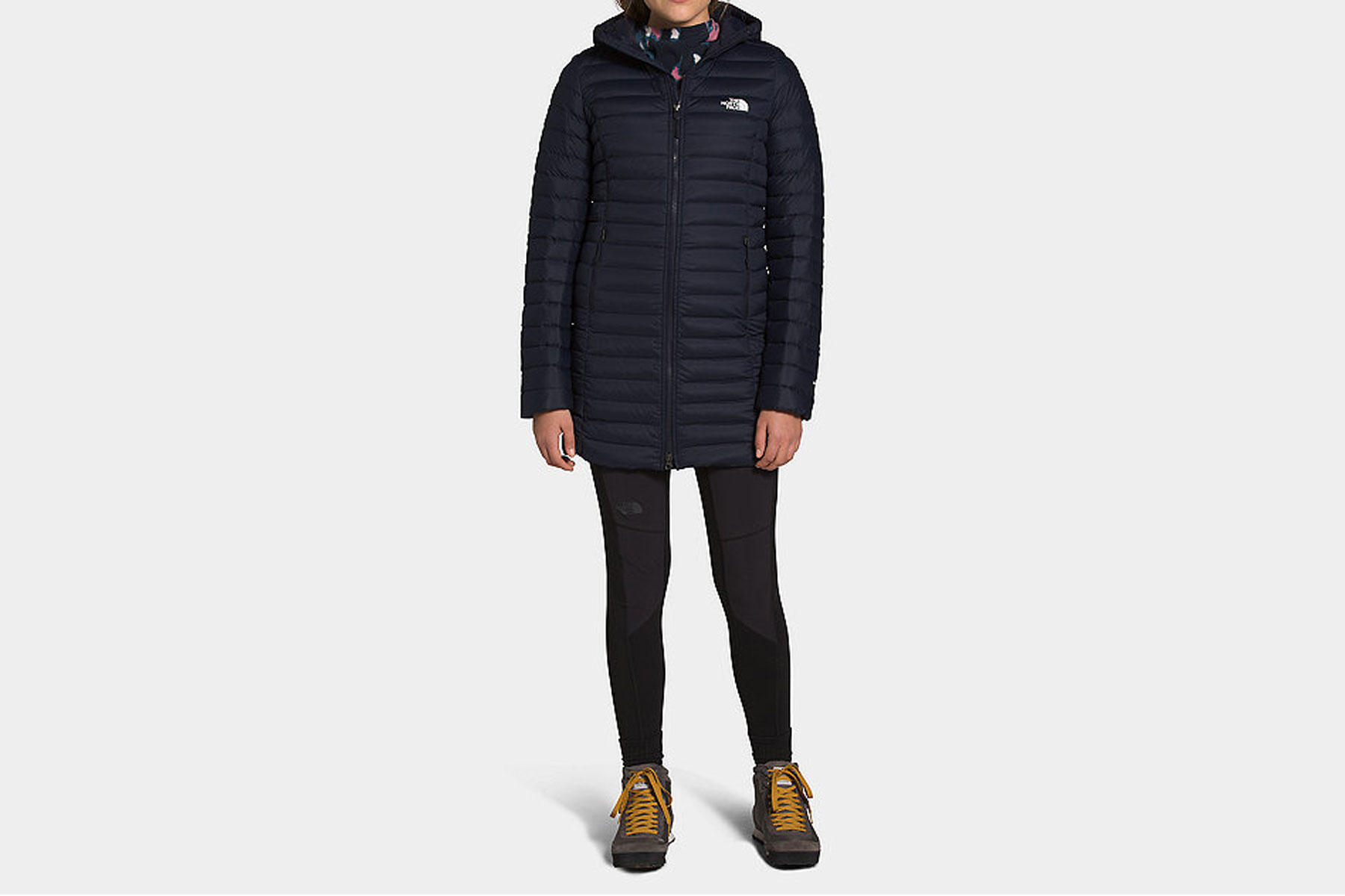 Woman wearing navy long puffer parka