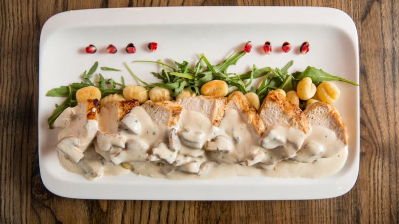 Chicken Mushroom Cream Sauce Plated Wooden Table